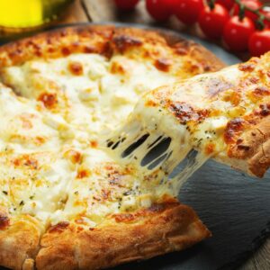 A slice of hot Italian pizza with stretching cheese. Pizza four cheeses with basil.